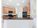 Well-lit kitchen featuring granite countertops, a black fridge, and ample light wood cabinetry at 644 Shorehaven Dr, Kissimmee, FL 34759