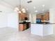 Bright kitchen features black appliances, granite countertops, light wood cabinets, and a large island at 644 Shorehaven Dr, Kissimmee, FL 34759