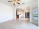 Spacious living room showcasing tile floors, natural light, and views into the kitchen and dining areas at 644 Shorehaven Dr, Kissimmee, FL 34759