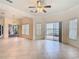 Open living room with tile floors, ceiling fan, and sliding glass doors that offer an abundance of natural light at 644 Shorehaven Dr, Kissimmee, FL 34759