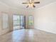 Bright living room with tile flooring, ceiling fan, and sliding glass doors to the outside at 644 Shorehaven Dr, Kissimmee, FL 34759
