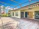 Back of house features a covered patio and screened-in area with views of the surrounding landscape at 644 Shorehaven Dr, Kissimmee, FL 34759