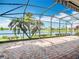 Spacious screened-in patio overlooking a lake, perfect for outdoor relaxation and entertaining at 644 Shorehaven Dr, Kissimmee, FL 34759