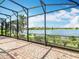 Screened-in patio provides a tranquil view of the lake and lush landscaping at 644 Shorehaven Dr, Kissimmee, FL 34759