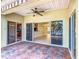 Comfortable covered patio with ceiling fan and sliding glass doors opening to the home's interior at 644 Shorehaven Dr, Kissimmee, FL 34759