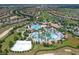 Aerial of a residential community with a pool, lazy river, sand volleyball court, and clubhouse at 860 Pebble Beach Dr, Davenport, FL 33896