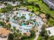 Aerial photo of a lazy river community pool with cabanas, lounge chairs, and lush tropical landscaping at 860 Pebble Beach Dr, Davenport, FL 33896