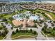 Overhead shot of a community pool with ample seating, palm trees, and a well-maintained clubhouse at 860 Pebble Beach Dr, Davenport, FL 33896