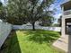 Well-manicured backyard featuring lush lawn and a privacy fence, perfect for relaxation and recreation at 9846 Palmetto Dunes Ct, Orlando, FL 32832