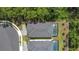This aerial view shows the tile roof of the houses and a screened in patio and pool at 1326 Butterfly Orchid Rd, Davenport, FL 33837