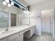 Bathroom with a double sink vanity, a large mirror and a glass enclosed shower at 1326 Butterfly Orchid Rd, Davenport, FL 33837