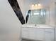 Modern bathroom features a combination shower-tub, a vanity, and a large mirror, creating a bright and stylish space at 1326 Butterfly Orchid Rd, Davenport, FL 33837
