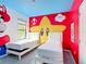 Themed bedroom with Mario decor and two twin beds at 1326 Butterfly Orchid Rd, Davenport, FL 33837
