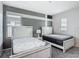 Bedroom with two beds, grey carpet, and wall paint with a grey and white color block at 1326 Butterfly Orchid Rd, Davenport, FL 33837