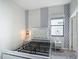 This bedroom features geometric patterned wallpaper, two gray nightstands, and a window with blinds for natural light at 1326 Butterfly Orchid Rd, Davenport, FL 33837