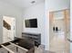 Spacious bedroom with a wall-mounted TV above a sleek dresser, bright and airy, ready for customization at 1326 Butterfly Orchid Rd, Davenport, FL 33837