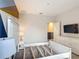 Bedroom with a white bed frame, a large headboard, modern lamp, and an open doorway at 1326 Butterfly Orchid Rd, Davenport, FL 33837
