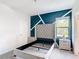 Stylish bedroom with decorative accent wall, bedside tables, and natural light at 1326 Butterfly Orchid Rd, Davenport, FL 33837