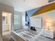 Bright bedroom featuring colorful accent wall and ensuite bathroom at 1326 Butterfly Orchid Rd, Davenport, FL 33837