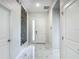 Bright entryway with marble tile floors, white door, and modern decor at 1326 Butterfly Orchid Rd, Davenport, FL 33837