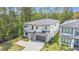 Contemporary two-story home with a two-car garage, gray roof, landscaping, and modern architecture at 1326 Butterfly Orchid Rd, Davenport, FL 33837