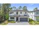 Beautiful two-story home featuring manicured landscaping, a two-car garage, and a stone-accented entrance at 1326 Butterfly Orchid Rd, Davenport, FL 33837