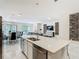 Modern kitchen features stainless steel appliances, marble flooring, and an open-concept design at 1326 Butterfly Orchid Rd, Davenport, FL 33837