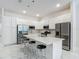 Bright kitchen featuring white cabinets, stainless steel appliances, a center island, and marble floors at 1326 Butterfly Orchid Rd, Davenport, FL 33837