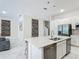 Spacious kitchen features an island with a sink and stainless steel appliances, and marble floors at 1326 Butterfly Orchid Rd, Davenport, FL 33837
