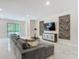 Spacious living room with a sectional sofa, marble floors, and modern artwork at 1326 Butterfly Orchid Rd, Davenport, FL 33837