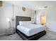 Elegant main bedroom with a tufted headboard and ensuite bathroom access at 1326 Butterfly Orchid Rd, Davenport, FL 33837