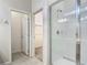 Modern bathroom with a glass-enclosed shower and neutral tile at 1326 Butterfly Orchid Rd, Davenport, FL 33837