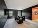 Home theater room with four recliners, dark walls, carpet, and a flat screen television at 1326 Butterfly Orchid Rd, Davenport, FL 33837