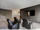 Home theater room with four recliners, dark walls, carpet, and a flat screen television at 1326 Butterfly Orchid Rd, Davenport, FL 33837