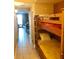 Bedroom including bunk beds and a view into the living room with outside access at 13415 Blue Heron Beach Dr # 304, Orlando, FL 32821