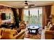 Inviting living room featuring a ceiling fan, balcony access, and neutral decor at 13415 Blue Heron Beach Dr # 304, Orlando, FL 32821