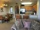 View of the dining and kitchen area featuring a breakfast bar and comfortable living room at 13415 Blue Heron Beach Dr # 304, Orlando, FL 32821