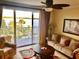 Bright living room with a water view, balcony access, and comfortable seating at 13415 Blue Heron Beach Dr # 304, Orlando, FL 32821