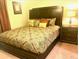 Cozy main bedroom with stylish patterned bedding and an elegant headboard at 13415 Blue Heron Beach Dr # 304, Orlando, FL 32821
