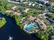 An aerial view highlights the community pool and amenities by the lake at 1357 Venezia Ct # 202, Davenport, FL 33896