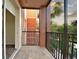 Balcony with tile flooring, metal railing, and a view of the water and palm trees at 1357 Venezia Ct # 202, Davenport, FL 33896