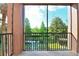 Balcony with tile flooring, metal railing, and a view of the lush greenery at 1357 Venezia Ct # 202, Davenport, FL 33896
