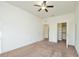 Expansive bedroom featuring neutral carpet, ceiling fan, and walk-in closet for ample storage at 1357 Venezia Ct # 202, Davenport, FL 33896