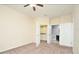 Neutral bedroom featuring carpet, closet, bathroom, and doors to enter them at 1357 Venezia Ct # 202, Davenport, FL 33896