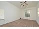 Bright bedroom with large window, ceiling fan, and carpet at 1357 Venezia Ct # 202, Davenport, FL 33896