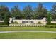 Inviting Bella Trae community sign with lush landscaping and a serene atmosphere at 1357 Venezia Ct # 202, Davenport, FL 33896