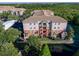 Beautiful multi-level condo building with lush landscaping and waterfront view at 1357 Venezia Ct # 202, Davenport, FL 33896