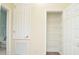 Bright hallway with a view of an organized, white-shelved storage closet and partial bathroom at 1357 Venezia Ct # 202, Davenport, FL 33896