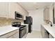 Charming kitchen featuring stainless steel appliances, tiled backsplash, and ample counter space at 1357 Venezia Ct # 202, Davenport, FL 33896