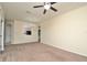 Bright living room featuring neutral walls, carpet, ceiling fan, and elegant chandelier at 1357 Venezia Ct # 202, Davenport, FL 33896